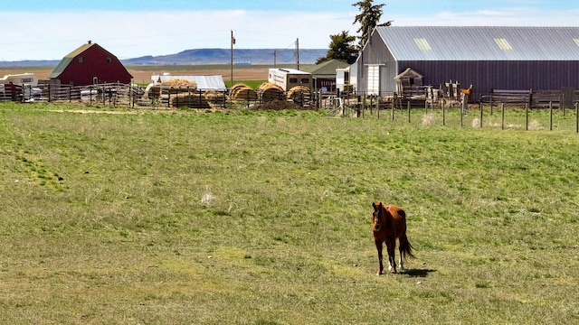 481 24th Rd NE, Dutton, MT 59433 - view of yard featuring an outdoor structure, a barn, a mountain view, and a view of rural / pastoral area