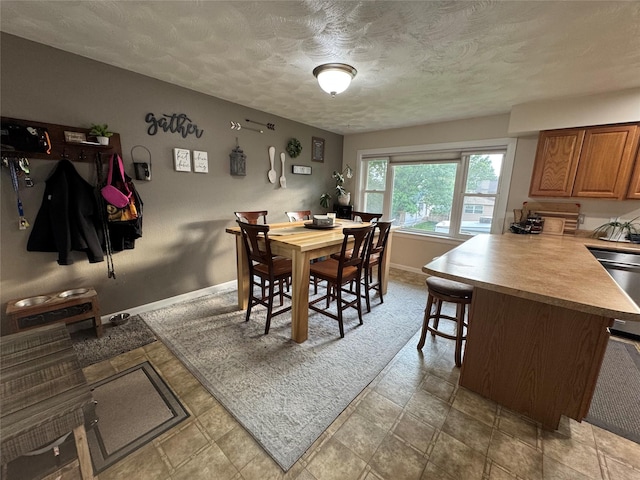 1631 Juniper Dr, Havre, MT 59501 - dining room with baseboards and a textured ceiling