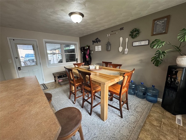 1631 Juniper Dr, Havre, MT 59501 - tiled dining area featuring a textured ceiling and baseboards