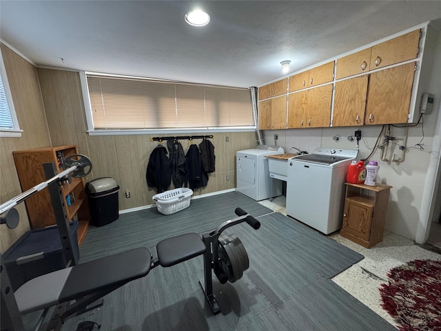 1631 Juniper Dr, Havre, MT 59501 - washroom featuring cabinet space, washer and dryer, and wood walls