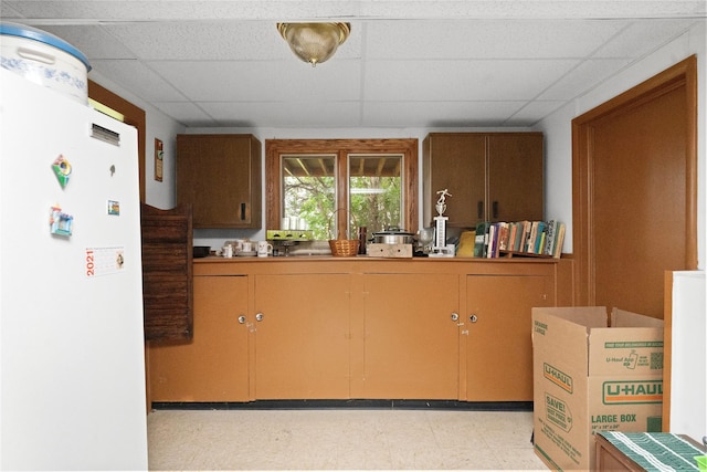 417 56th St S, Great Falls, MT 59405 - kitchen with freestanding refrigerator, a paneled ceiling, and light flooring