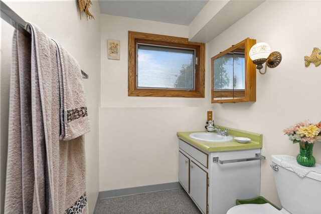 417 56th St S, Great Falls, MT 59405 - bathroom featuring toilet, vanity, healthy amount of natural light, and baseboards