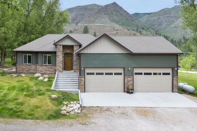 12800 Mill Creek Rd, Lolo, MT 59847 - view of front of property with stone siding, driveway, a front yard, and a mountain view