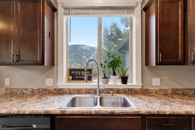 12800 Mill Creek Rd, Lolo, MT 59847 - kitchen with a sink, dishwashing machine, dark brown cabinets, a mountain view, and light countertops