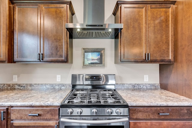 12800 Mill Creek Rd, Lolo, MT 59847 - kitchen featuring stainless steel gas range, wall chimney exhaust hood, and light countertops