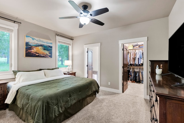 12800 Mill Creek Rd, Lolo, MT 59847 - bedroom with light carpet, a spacious closet, multiple windows, and ensuite bath
