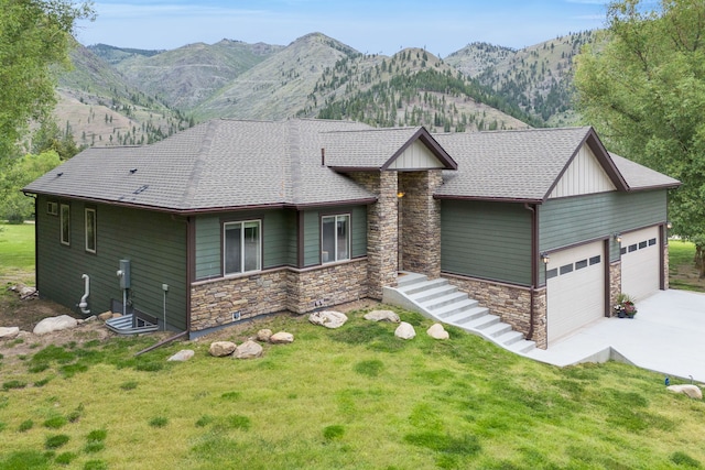 12800 Mill Creek Rd, Lolo, MT 59847 - view of front facade featuring stone siding, an attached garage, concrete driveway, and a front yard