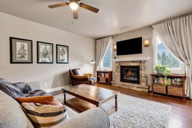 12800 Mill Creek Rd, Lolo, MT 59847 - living area with a ceiling fan, a stone fireplace, wood finished floors, and baseboards