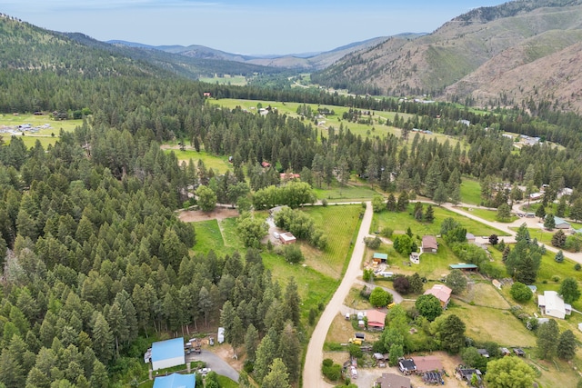 12800 Mill Creek Rd, Lolo, MT 59847 - aerial overview of property's location featuring a mountainous background and a heavily wooded area