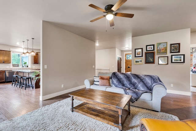 12800 Mill Creek Rd, Lolo, MT 59847 - living area featuring ceiling fan, wood finished floors, and baseboards