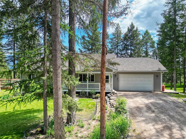 4357 Trumble Creek Rd, Columbia Falls, MT 59912 - view of front facade featuring an attached garage, driveway, a porch, and a front yard