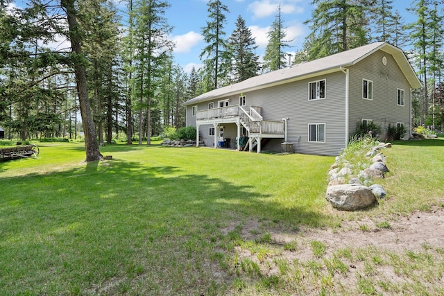 4357 Trumble Creek Rd, Columbia Falls, MT 59912 - back of house with a wooden deck, stairs, a yard, and central AC