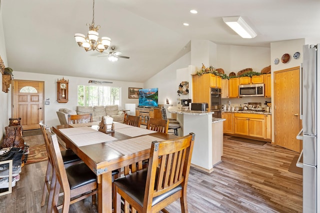 4357 Trumble Creek Rd, Columbia Falls, MT 59912 - dining area featuring a chandelier, high vaulted ceiling, light wood-style floors, and ceiling fan