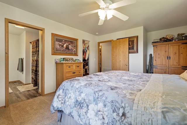 4357 Trumble Creek Rd, Columbia Falls, MT 59912 - carpeted bedroom with baseboards, a walk in closet, ceiling fan, a closet, and ensuite bath