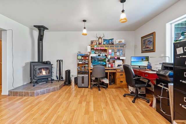 4357 Trumble Creek Rd, Columbia Falls, MT 59912 - office area featuring wood finished floors and a wood stove