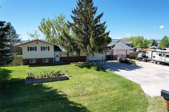1021 Vallejo Rd, Helena, MT 59602 - split level home featuring driveway, an attached garage, brick siding, and a vegetable garden