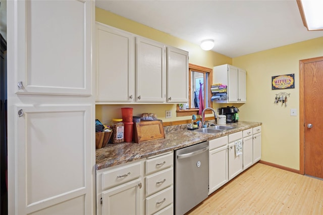 1021 Vallejo Rd, Helena, MT 59602 - kitchen featuring a sink, stainless steel dishwasher, light wood finished floors, white cabinetry, and baseboards