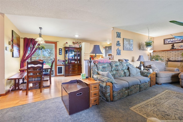 1021 Vallejo Rd, Helena, MT 59602 - carpeted living room with a textured ceiling, a fireplace, and wood finished floors
