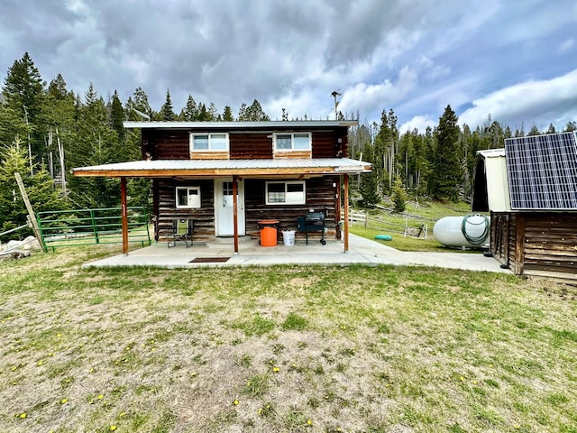 22 Indian Creek Rd, Townsend, MT 59644 - rear view of house with a patio, metal roof, and log siding