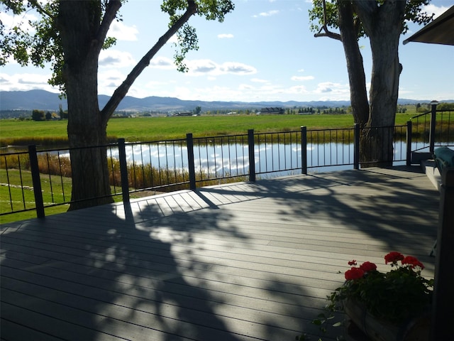 1340 Honey House Ln, Corvallis, MT 59828 - wooden terrace with a water and mountain view
