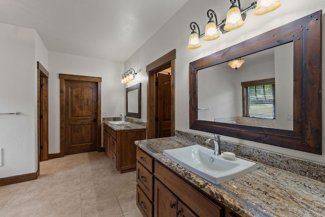 74 Wood Ridge Dr, Columbia Falls, MT 59912 - full bath with two vanities, baseboards, and tile patterned flooring