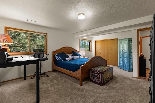 4750 Mark Ct, Missoula, MT 59803 - carpeted bedroom featuring multiple windows, a textured ceiling, a closet, and a desk