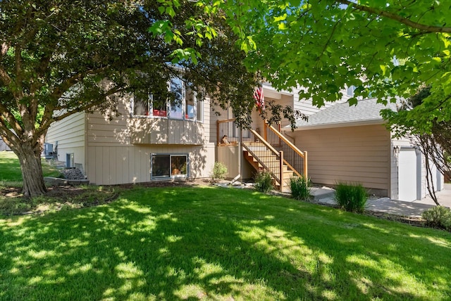 4750 Mark Ct, Missoula, MT 59803 - rear view of house featuring a yard, stairs, and an attached garage