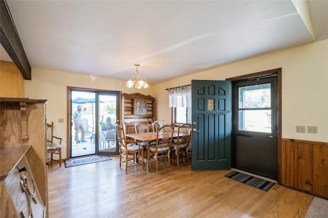 965 Ranch Ln, Kalispell, MT 59901 - foyer featuring light wood-style flooring, a chandelier, plenty of natural light, a wainscoted wall, and wood walls