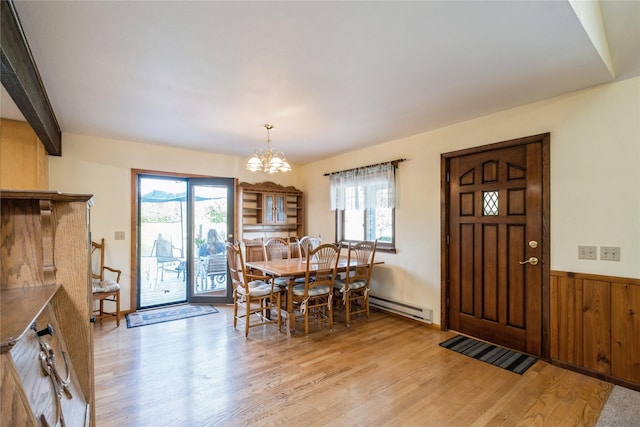 965 Ranch Ln, Kalispell, MT 59901 - dining room featuring a baseboard radiator, light wood-style floors, a chandelier, and plenty of natural light