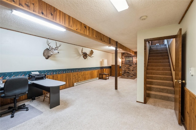 965 Ranch Ln, Kalispell, MT 59901 - office area featuring a baseboard radiator, light carpet, a wainscoted wall, a textured ceiling, and wooden walls