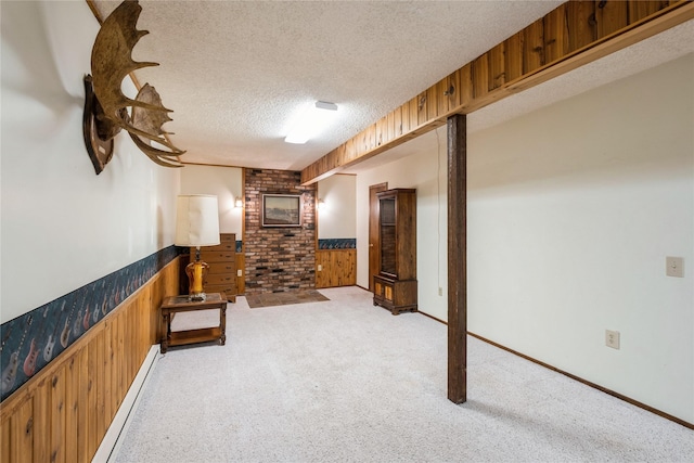 965 Ranch Ln, Kalispell, MT 59901 - corridor featuring a wainscoted wall, a textured ceiling, a baseboard radiator, light colored carpet, and wood walls