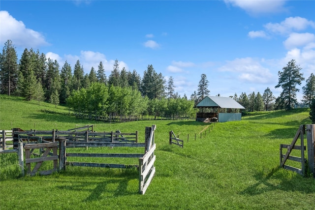 965 Ranch Ln, Kalispell, MT 59901 - view of green lawn featuring an outbuilding, an exterior structure, and a view of countryside