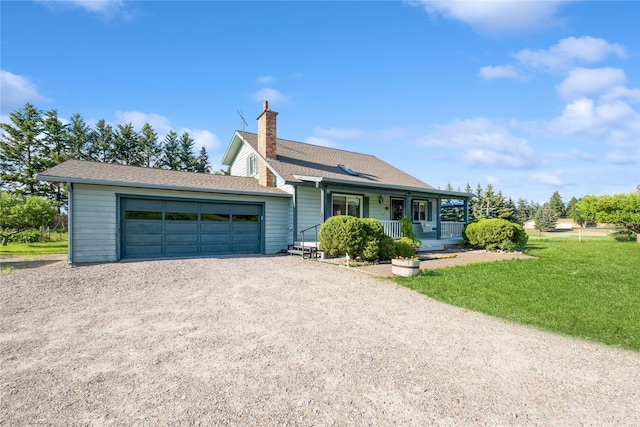 965 Ranch Ln, Kalispell, MT 59901 - ranch-style home featuring a chimney, a porch, driveway, an attached garage, and a front yard
