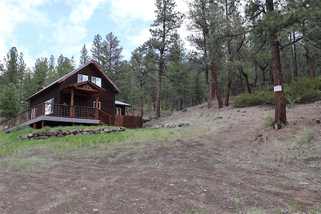208 Paul Creek Ln, Cascade, MT 59421 - view of front of home with a wooden deck and a forest view