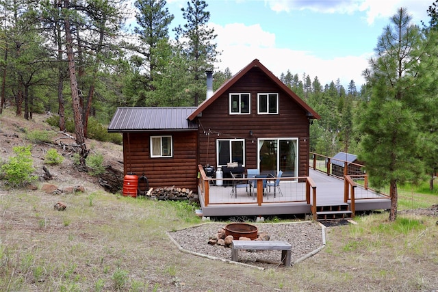 208 Paul Creek Ln, Cascade, MT 59421 - back of house featuring a fire pit, a wooden deck, metal roof, and log veneer siding
