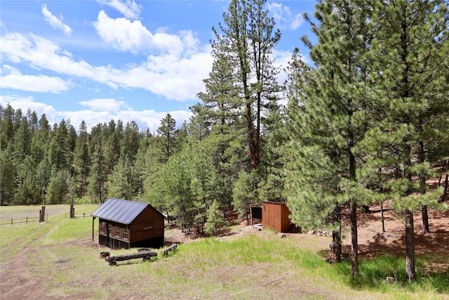 208 Paul Creek Ln, Cascade, MT 59421 - view of yard featuring an outdoor structure and a view of trees