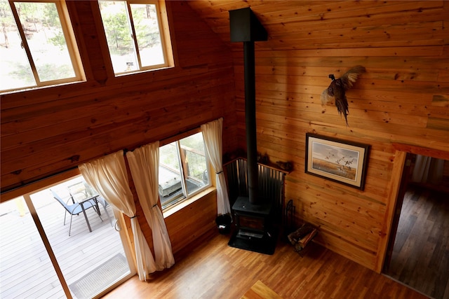 208 Paul Creek Ln, Cascade, MT 59421 - unfurnished room featuring a wood stove, wood walls, and light wood-style flooring
