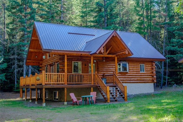 29 Northshore Dr, Troy, MT 59935 - view of front of house with log siding, stairway, a view of trees, metal roof, and a front yard