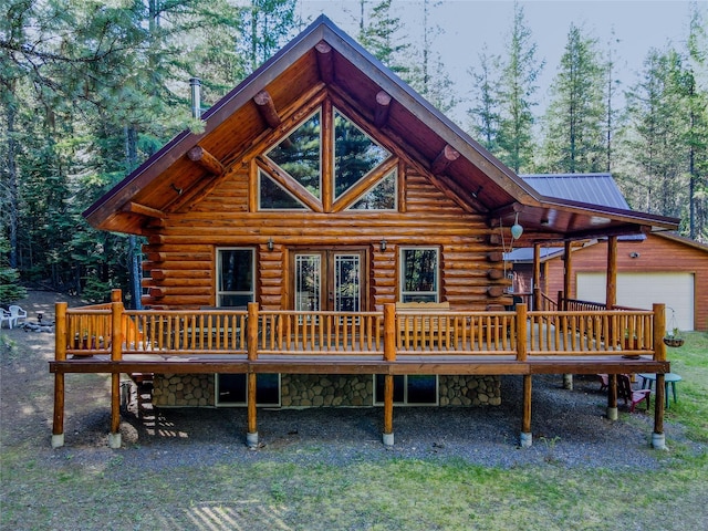 29 Northshore Dr, Troy, MT 59935 - rear view of house with log exterior, a wooden deck, an outbuilding, and a detached garage