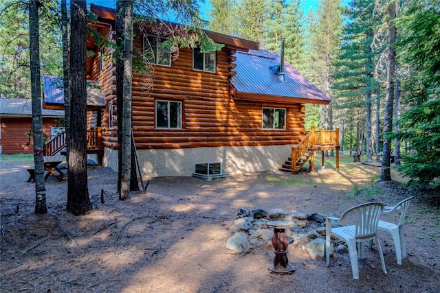 29 Northshore Dr, Troy, MT 59935 - back of property with stairway, log exterior, metal roof, and a deck