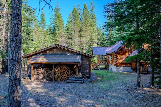 29 Northshore Dr, Troy, MT 59935 - exterior space featuring metal roof, a forest view, stone siding, log exterior, and stairs