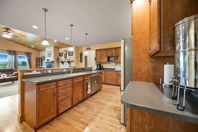 1399 Mackinaw Loop, Somers, MT 59932 - kitchen featuring dark countertops, stainless steel appliances, brown cabinets, light wood finished floors, and recessed lighting