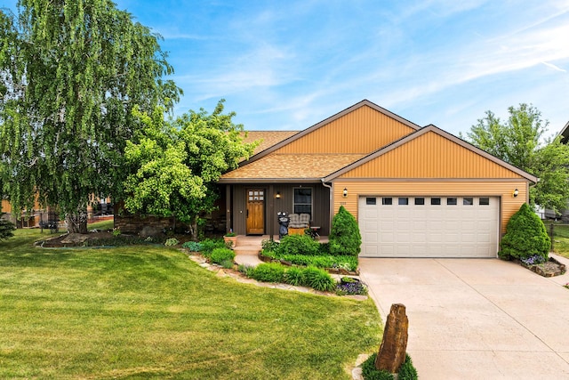 1399 Mackinaw Loop, Somers, MT 59932 - view of front of home featuring an attached garage, a front yard, driveway, and a shingled roof