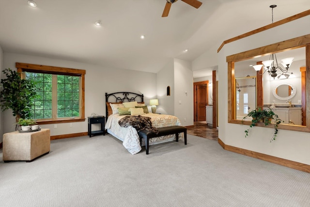 244 Pine Valley Ct, Columbia Falls, MT 59912 - carpeted bedroom featuring baseboards, lofted ceiling, a chandelier, ceiling fan, and connected bathroom