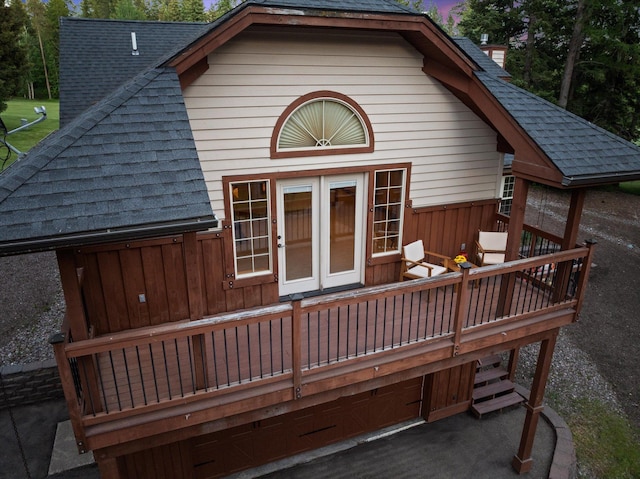 244 Pine Valley Ct, Columbia Falls, MT 59912 - rear view of house with a shingled roof and a wooden deck