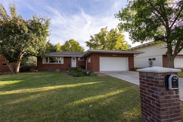 1511 E Broadway St, Helena, MT 59601 - view of front of home with brick siding, an attached garage, concrete driveway, and a front yard