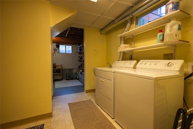 1511 E Broadway St, Helena, MT 59601 - laundry room with separate washer and dryer, light tile patterned floors, and baseboards