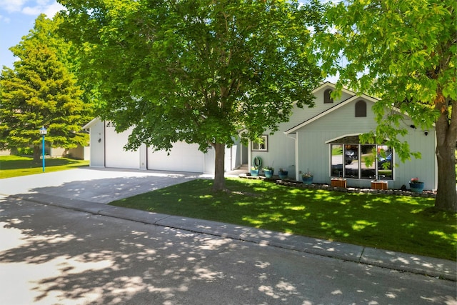 238 Red Fox Rd, Lolo, MT 59847 - view of property hidden behind natural elements featuring a front yard, driveway, and an attached garage