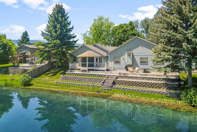 238 Red Fox Rd, Lolo, MT 59847 - rear view of property featuring a deck with water view