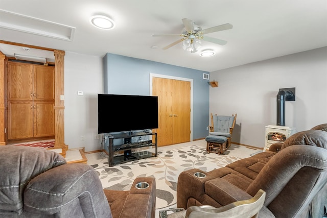 238 Red Fox Rd, Lolo, MT 59847 - living room featuring a wood stove, baseboards, and ceiling fan